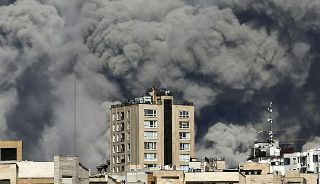 Thick smoke billows over buildings, potentially impacting business in the Gulf.