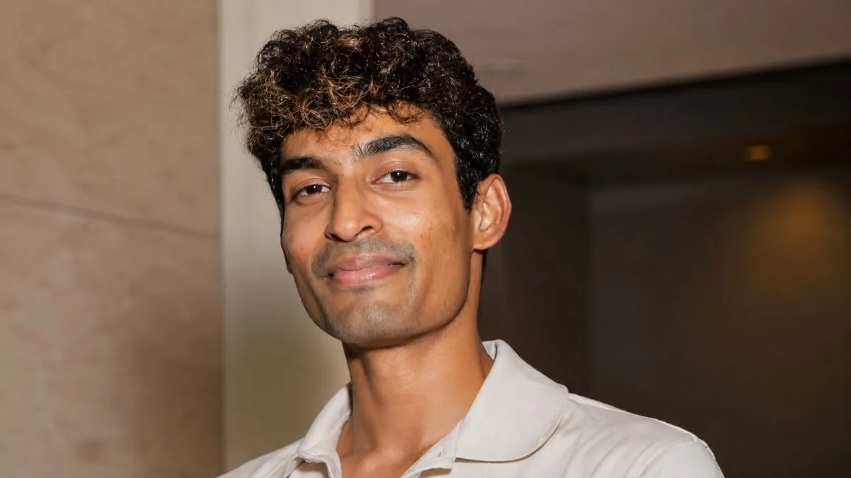 Indian tech startup founder smiles, representing innovation in Silicon Valley.