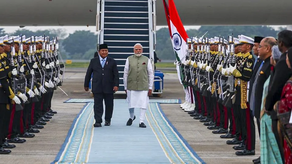 PM Modi in Indonesia, escorted by military officers, during official visit