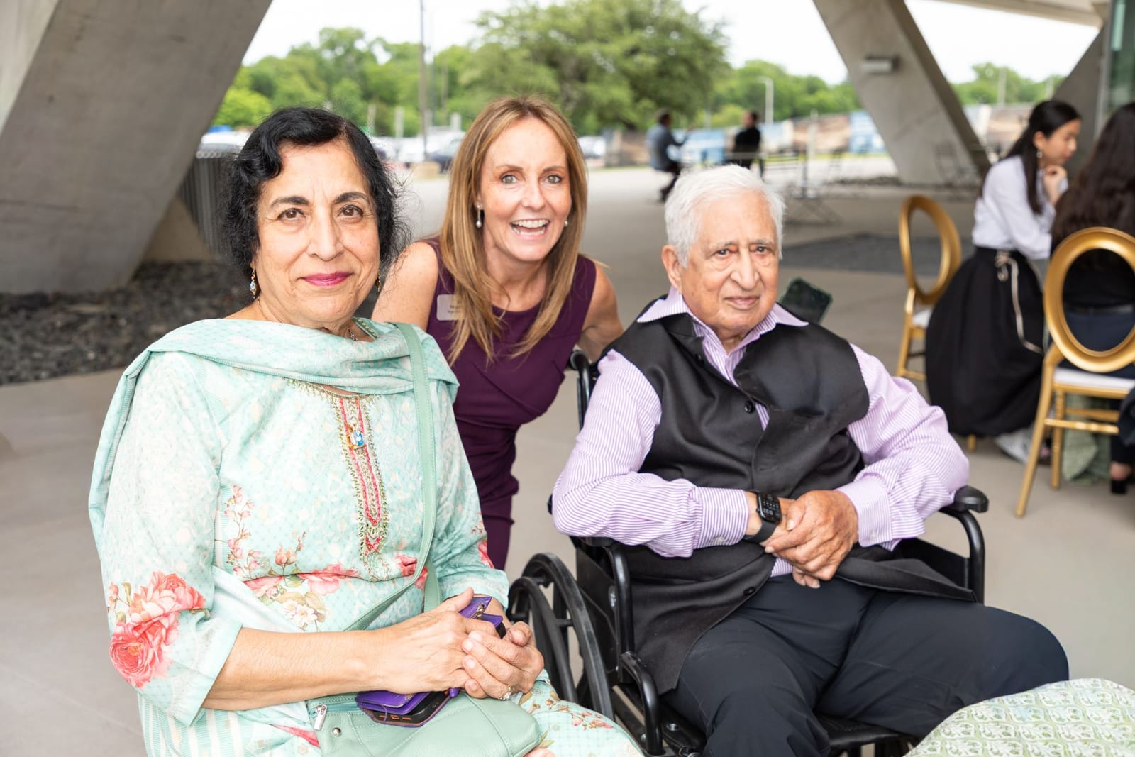 Indian American couple and a woman at Texas University event, politics.