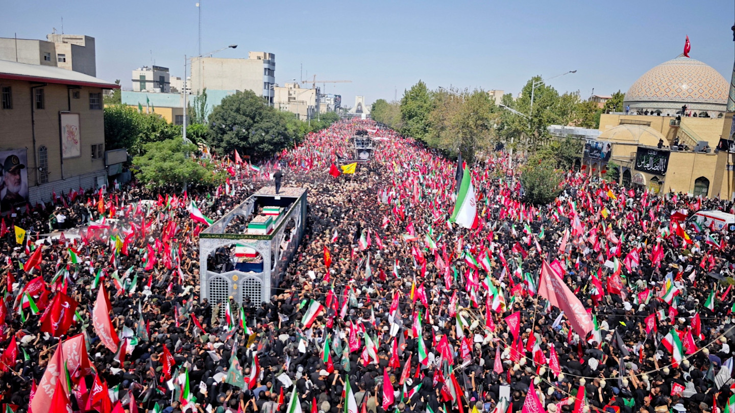 Massive Iran funeral crowd with flags chanting anti-Trump slogans.