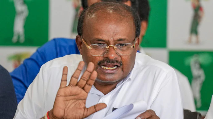 H.D. Kumaraswamy gestures during a press conference regarding Karnataka politics.