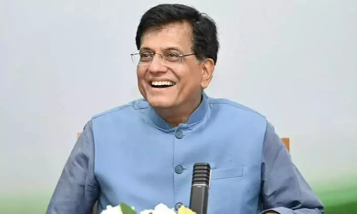Piyush Goyal, Indian Minister, smiling in blue vest, discussing business