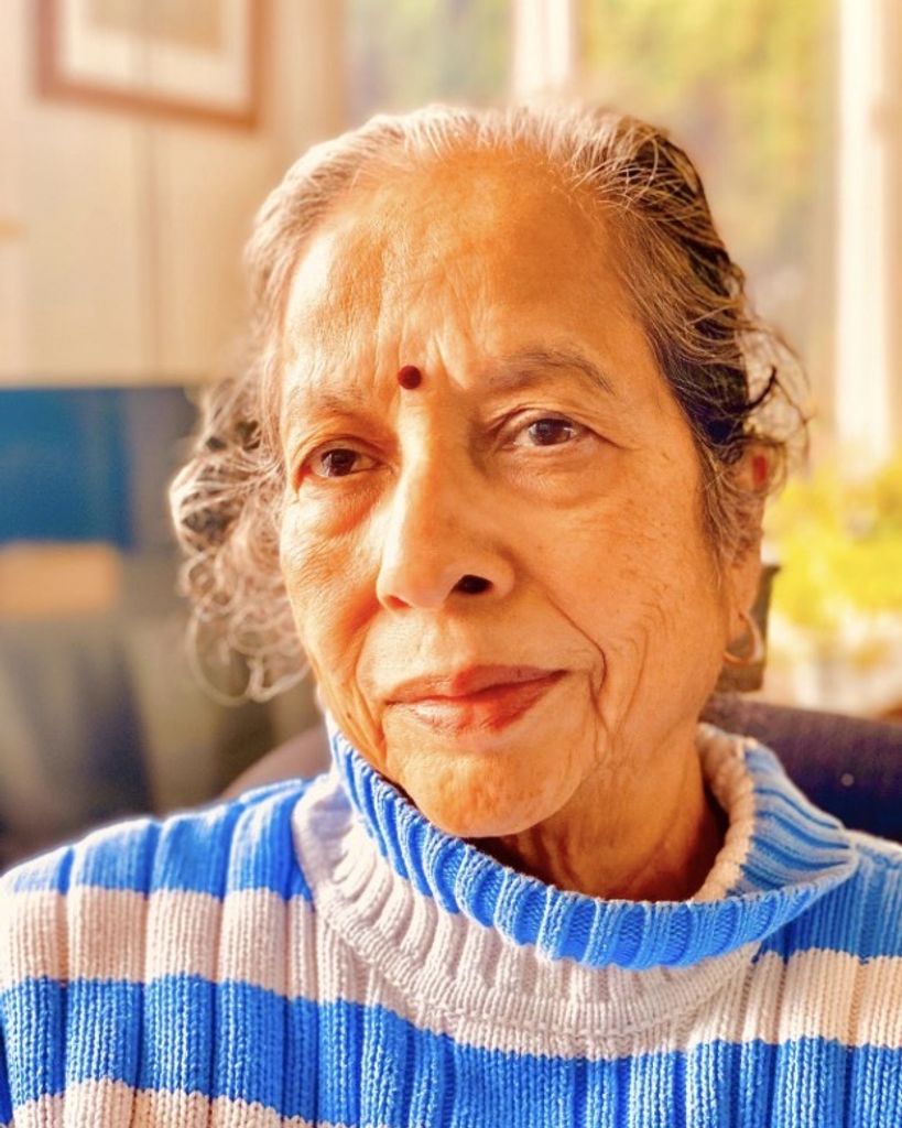 Indian-American leader Dr. Geeta Trivedi in a blue and white striped sweater.