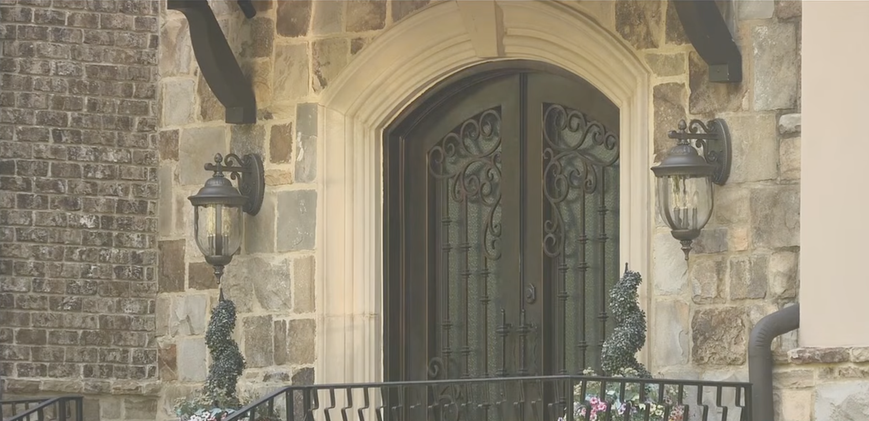 Exterior of a stone home with ornate double doors, possibly related to a Georgia Tech leader.