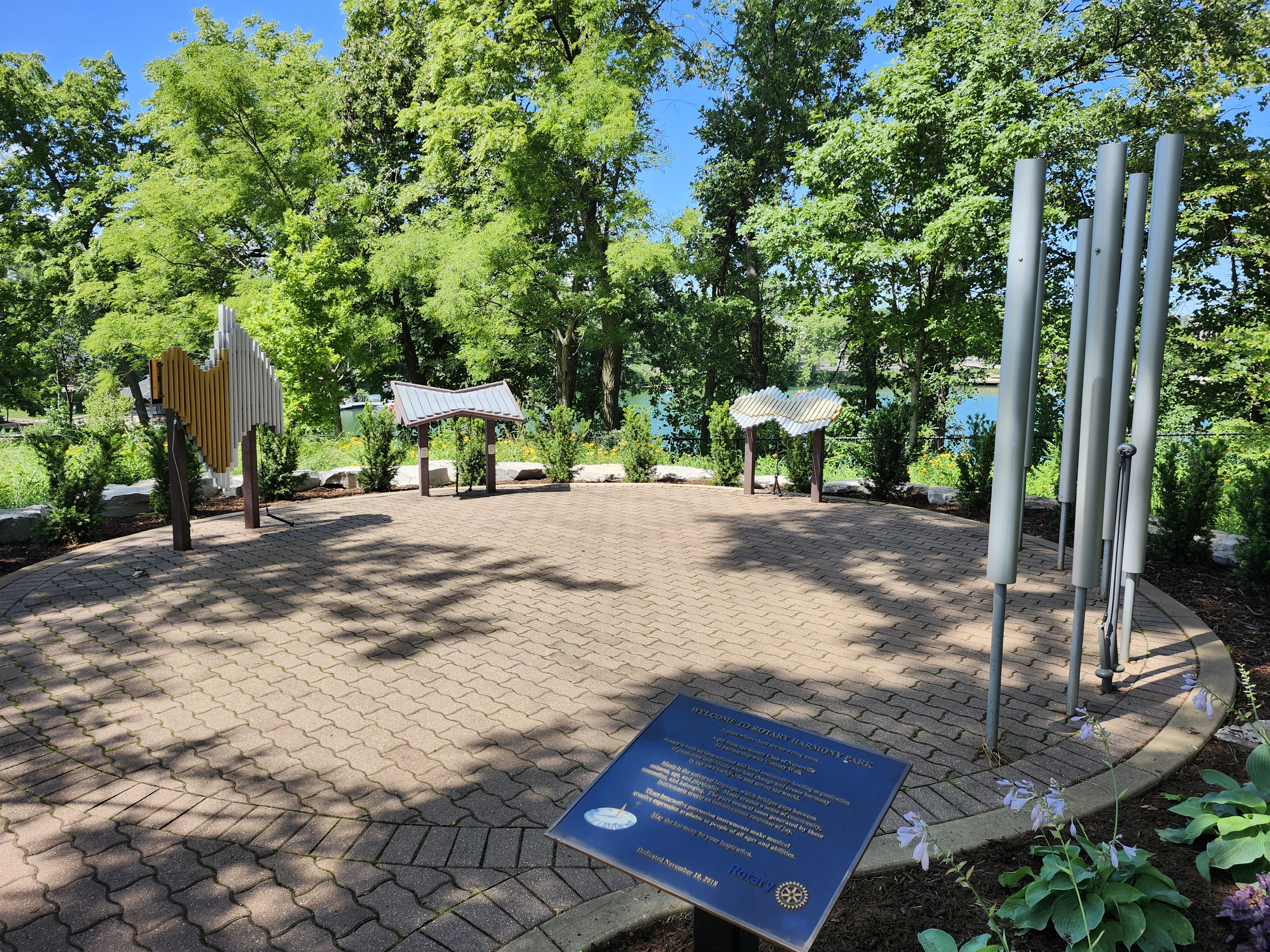 Naperville's Rotary Harmony Park with musical sculptures and a plaque.