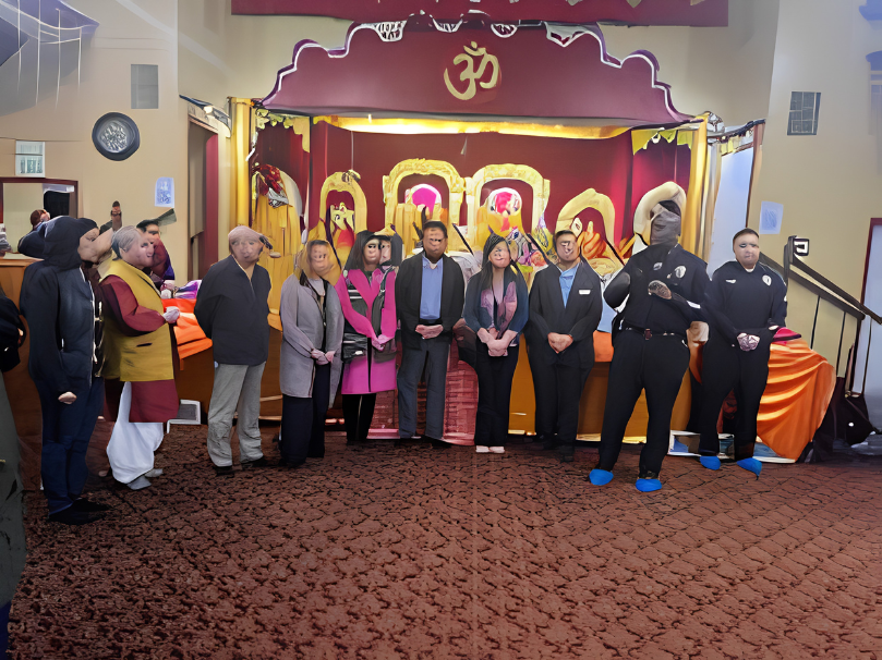 Police Chief Floyd Mitchell greets Fremont temple faithful, showcasing cultural diversity.