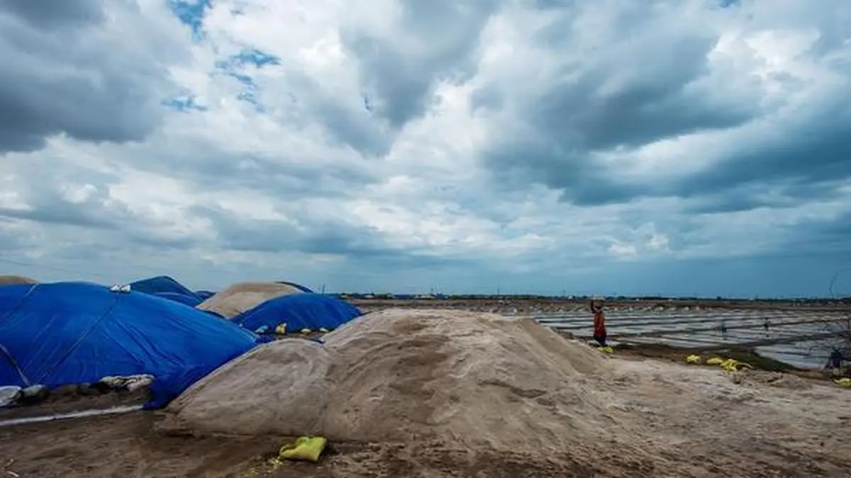 Salt pans and tarps under cloudy sky, Visakhapatnam
