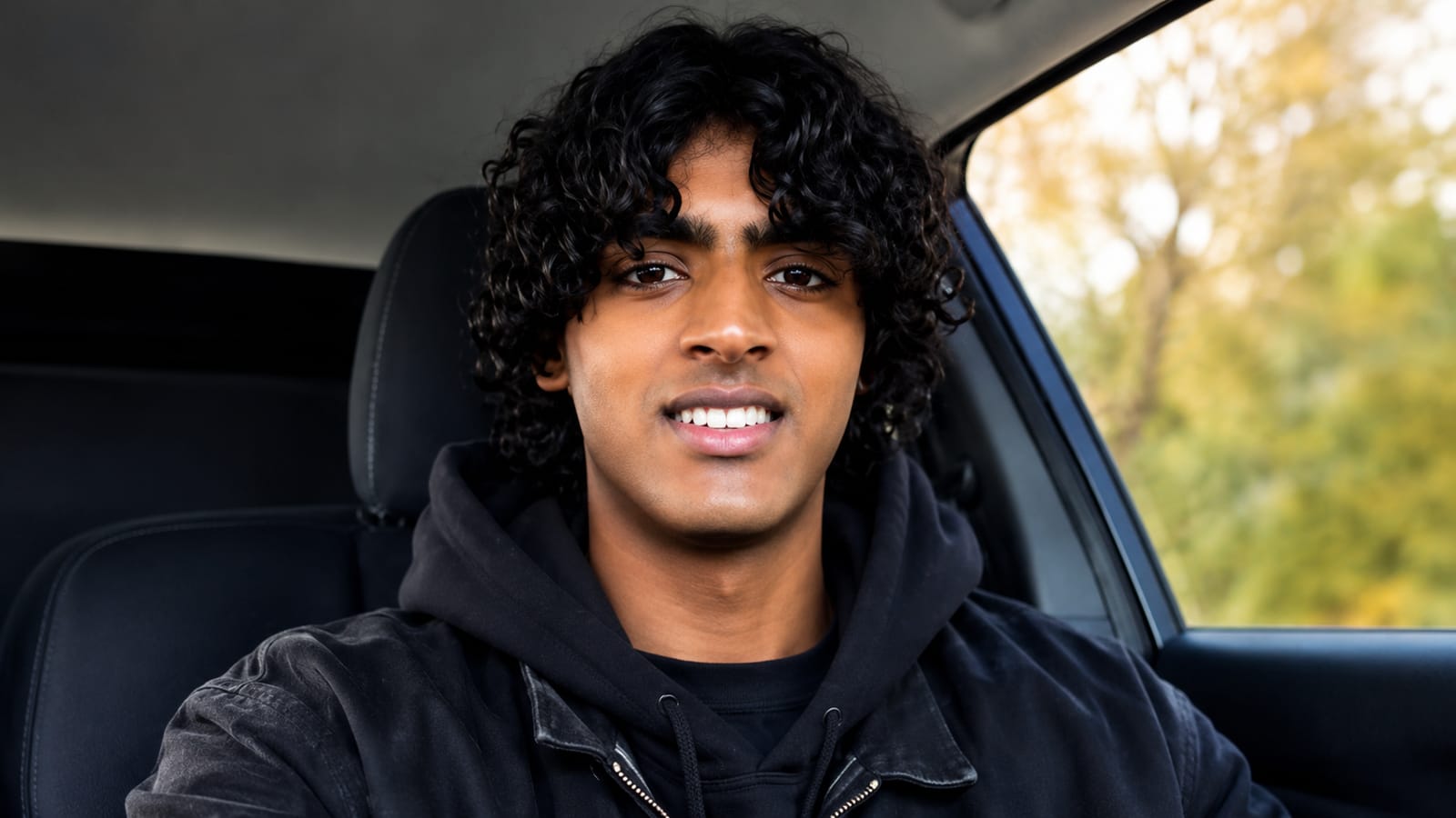 Young Indian American teen in a car, relevant to tech and AI searches.
