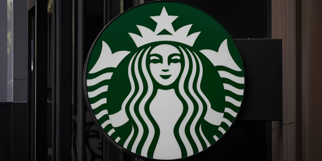 Starbucks logo, featuring the siren, in green and white. Tech innovation.