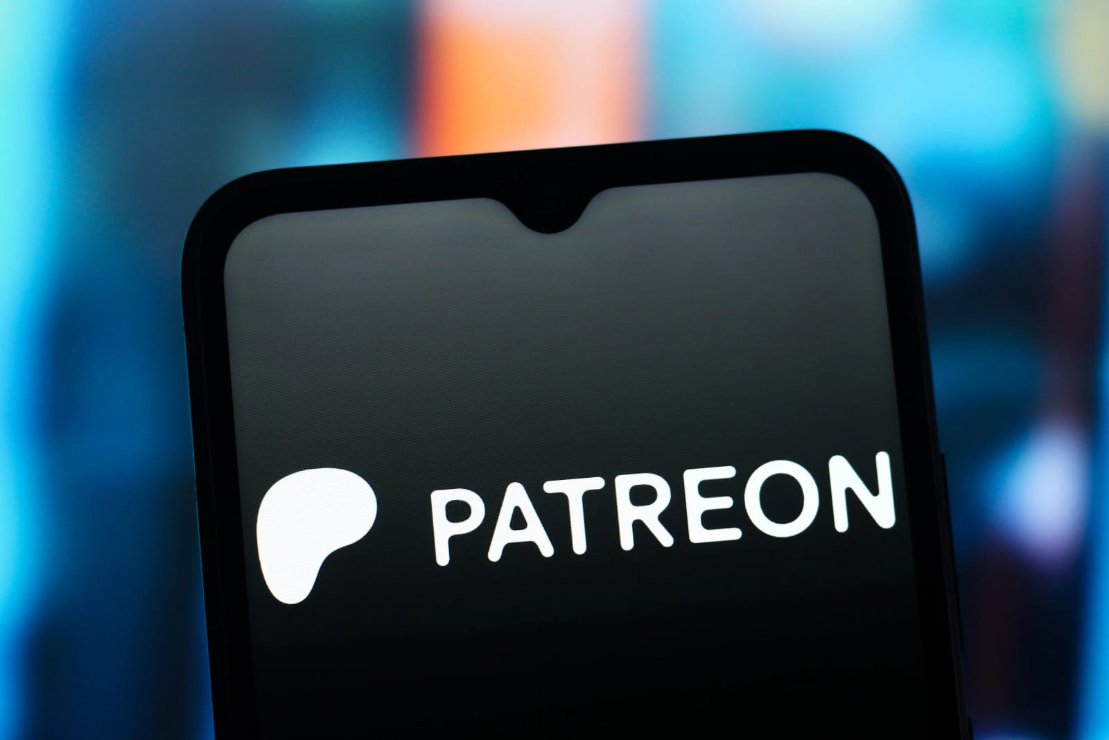 Patreon logo on a smartphone screen, reflecting tech industry changes.