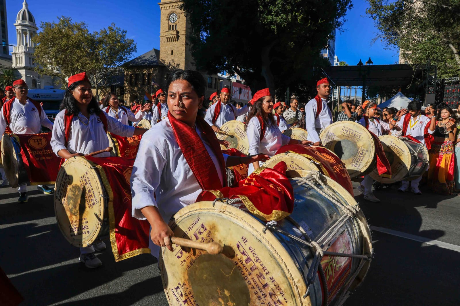 Dhol drummers in red and white celebrate India's Independence Day at SWADES 2026 news.