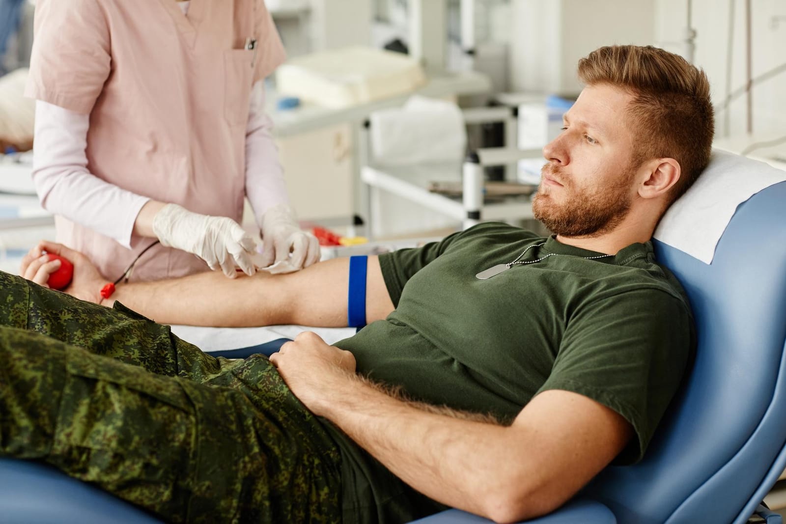 Man in military uniform undergoes blood draw for Pentagon testosterone screening.